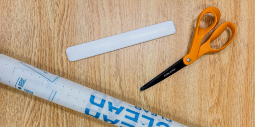 book repair kit essentials tape scissors and plastic covering